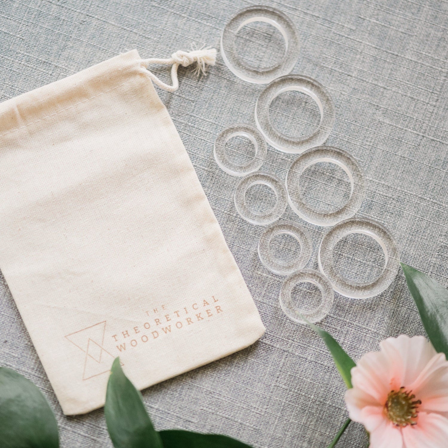 8 acrylic rings on a flat lay with a linen bag